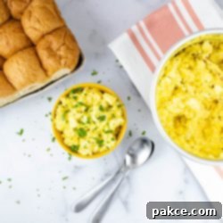 The Ultimate No Peel Instant Pot Egg Salad 2 Overhead view of prepared egg salad garnished with chopped parsley and whole wheat bread to the side