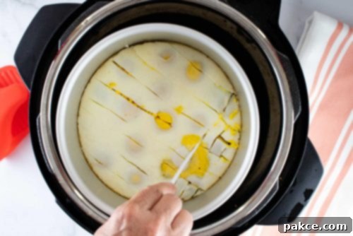 Overhead view of a layer of cooked eggs in an inner pot in an Instant Pot being cut into squares