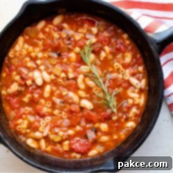 Pasta and Bean Soup 2 Cast iron skillet with Pasta e Fagioli, a soup made with pasta,tomatoes, chopped celery and onion, cannellini beans, and tomato sauce.