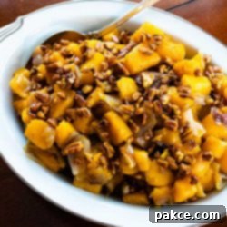 Caramelized Pecan Butternut Squash 2 A beautifully presented bowl of roasted butternut squash with candied pecans, garnished and ready to serve.