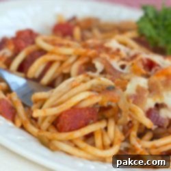Hearty Spaghetti Casserole 2 Baked spaghetti on white plate with a fork