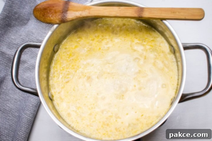 30 Minute Crispy Hash Brown Potato Soup 4 The potato soup after simmering and blending, showing a thick, creamy consistency with some visible potato pieces.