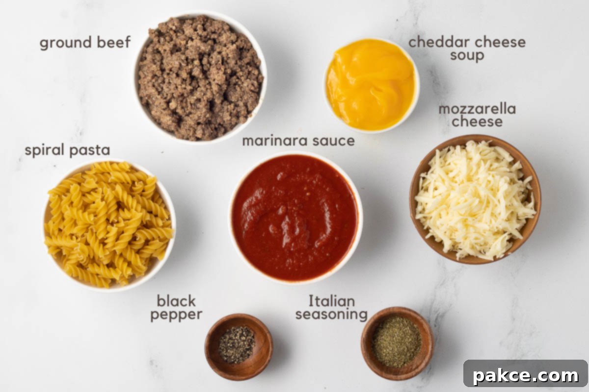 Gooey Golden Spirals 3 Ingredients for Spiral Pasta recipe: cooked ground beef, spiral pasta, marinara sauce, condensed cheddar cheese soup, shredded mozzarella cheese, Italian seasoning, and black pepper.