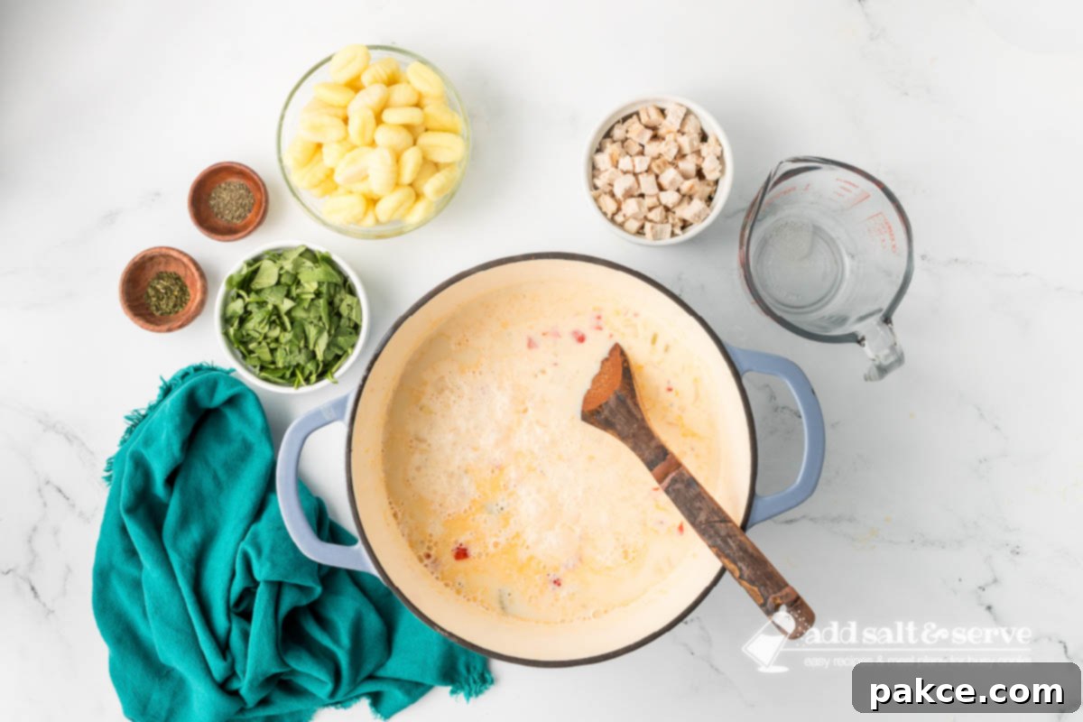 Recreate Olive Garden's Chicken Gnocchi Soup at Home 6 Simmering cream, chicken broth, and sautéed onion, garlic, celery, and bell pepper for Chicken Gnocchi Soup in a Dutch oven.