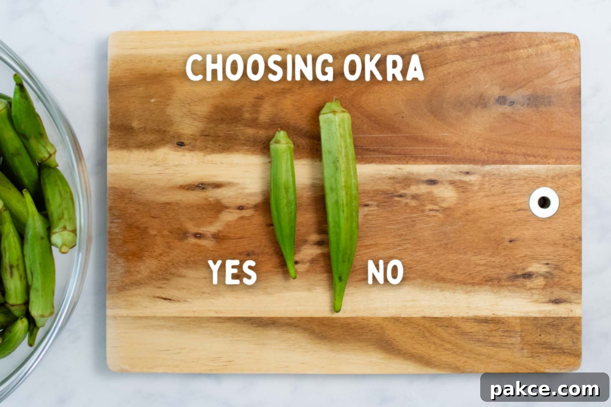 Roasted Okra and Onions Sheet Pan Simplicity 5 Two pieces of okra on a cutting board with text Choosing Okra; one is long and fat with text No, and one is short and slender with text Yes.