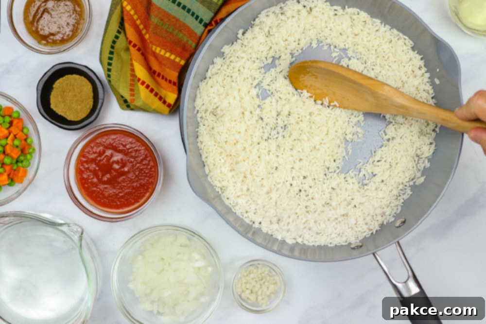Vibrant Mexican Veggie Rice 4 Rice browning in a skillet with a wooden spoon, surrounded by other ingredients for Restaurant Style Mexican Rice