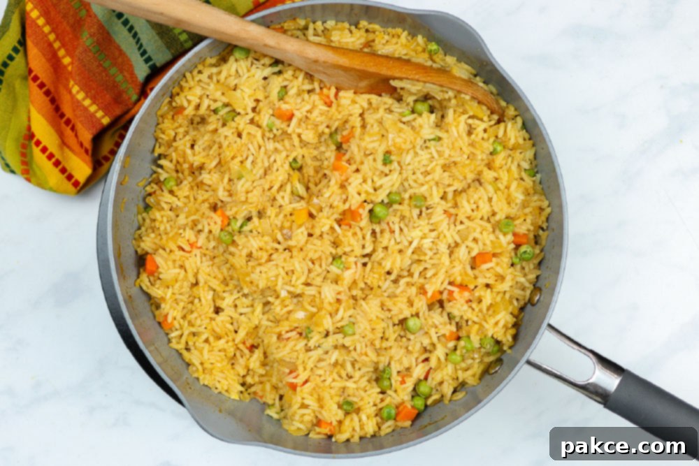 Vibrant Mexican Veggie Rice 8 Restaurant Style Mexican Rice in a skillet, freshly cooked and ready to be served