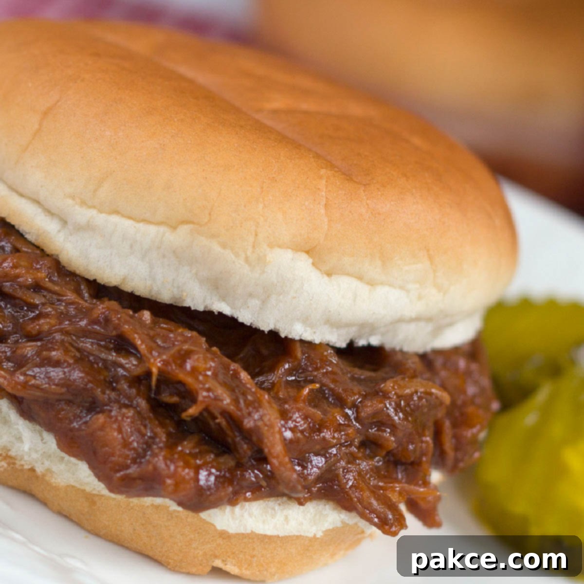 Barbecue Roast Beef Sandwich garnished with two pickle slices.
