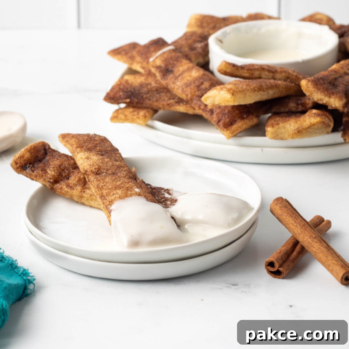 Effortless Cinnamon Sticks from Pizza Dough 11 Baked cinnamon sticks encrusted with cinnamon sugar in butter and served with vanilla icing.