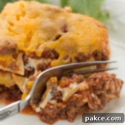 Stacked Italian Beef Bake 3 A slice of Layered Italian Beef Casserole being cut by a fork