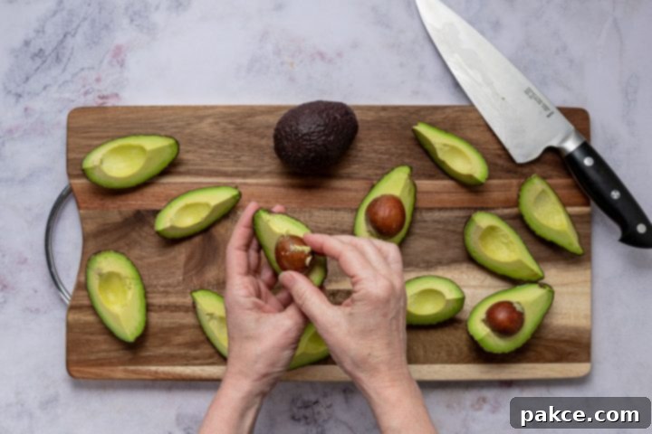 Effortless Homemade Guacamole Guide 4 peeling avocado quarters