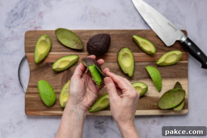 Effortless Homemade Guacamole Guide 5 Several quartered and pitted avocados on a cutting board