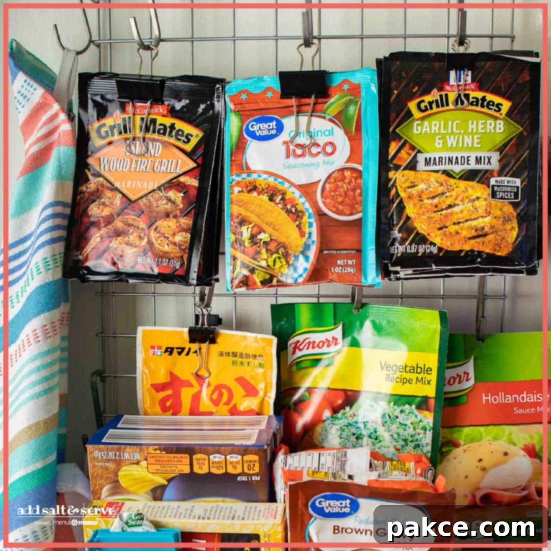 Pantry Perfection: Simple Organizing Tricks 2 Various sauce and seasoning packets neatly organized and hanging on s-hooks from a wire shelf in a pantry, showcasing efficient vertical storage.