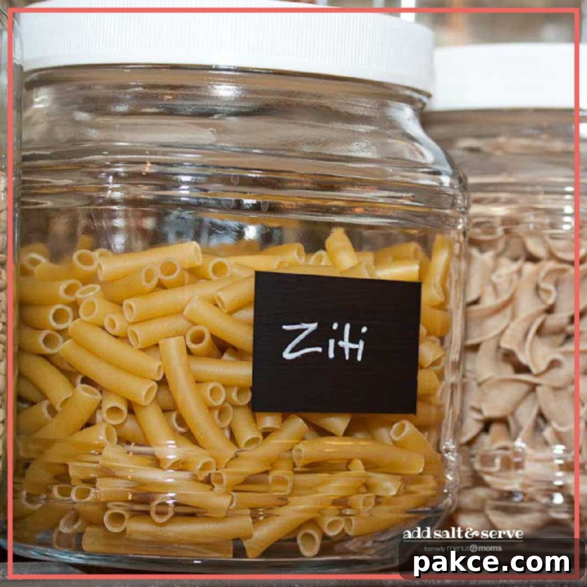 Pantry Perfection: Simple Organizing Tricks 4 A glass jar filled with uncooked ziti pasta, featuring a DIY chalkboard paint label with 'Ziti' clearly written in chalk, sitting neatly on a pantry shelf.