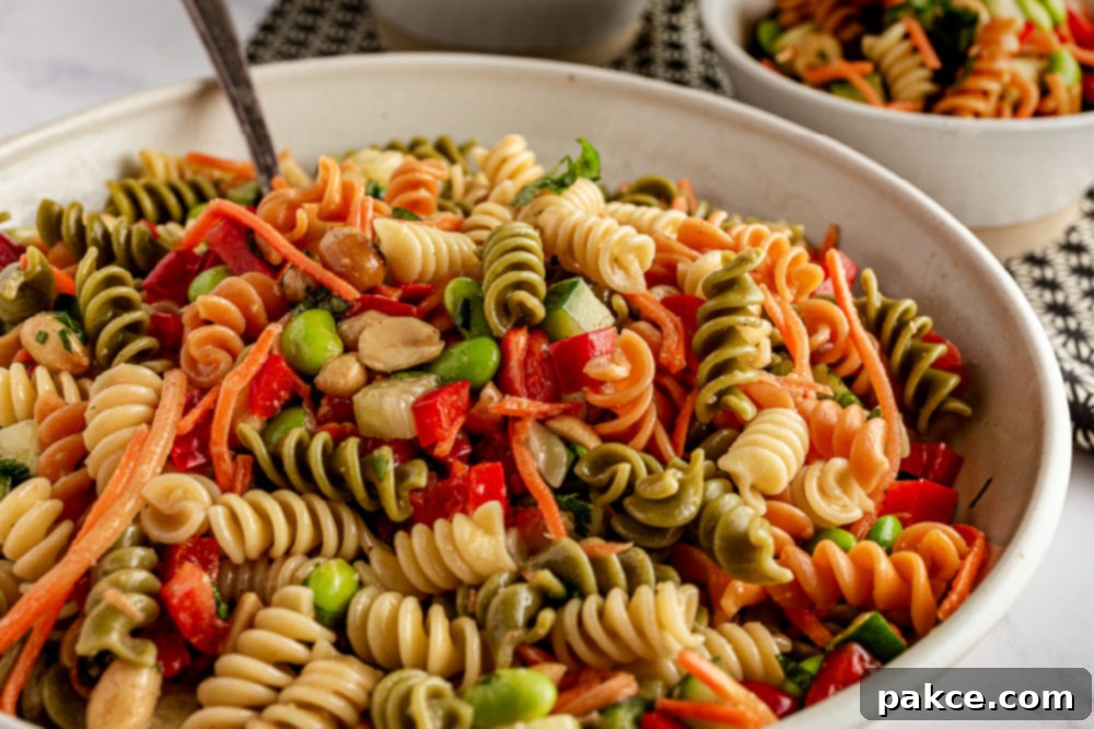 Vibrant Thai Pasta Salad with Sesame-Ginger Dressing in a large bowl, ready to serve