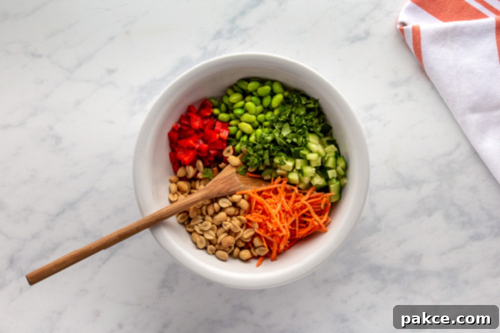 Thai Pasta Salad with Sesame Ginger Dressing 6 Carrots, Red Bell Pepper, peanuts, edamame, and cilantro pre-mixed in a bowl for Thai Pasta Salad
