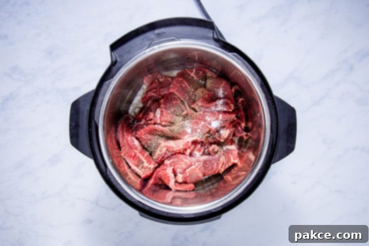 Instant Pot French Onion French Dip 4 seasoned sliced chuck steak in the instant pot