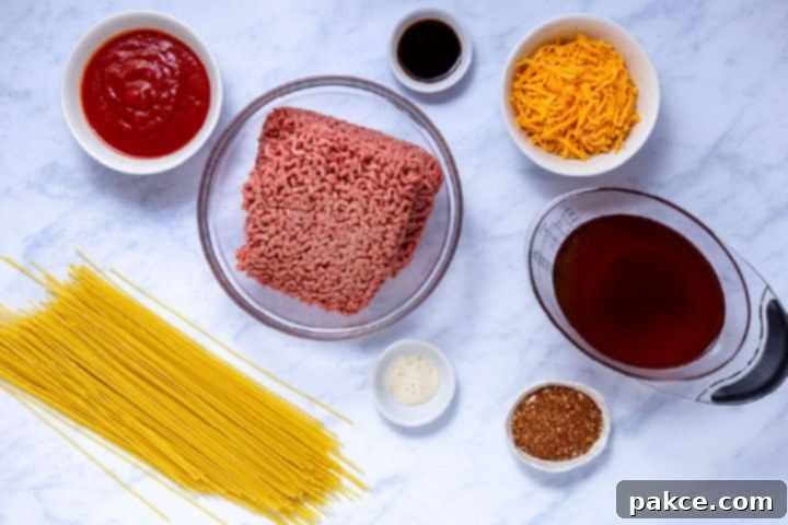 The Legend of Terlingua Chili 3 Collection of fresh ingredients for a Terlingua chili recipe, including ground beef, tomato sauce, and spices.