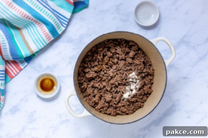 The Legend of Terlingua Chili 6 Cooked ground beef with Worcestershire sauce and seasoned salt in a Dutch oven, stirred together.