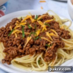 The Legend of Terlingua Chili 10 Terlingua chili over spaghetti garnished with cheese