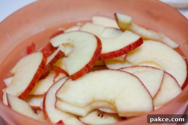 Bowl of sliced apples and text Add Salt & Serve