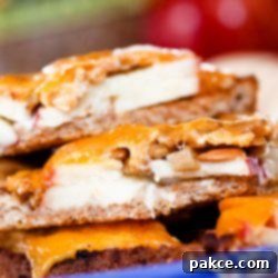 Sweet Apple Sharp Cheddar Melt 2 Image of bread with mayo, apple slices, and sunflower seeds topped with melted cheddar and text Open-faced Apple Cheddar Melt Sandwich