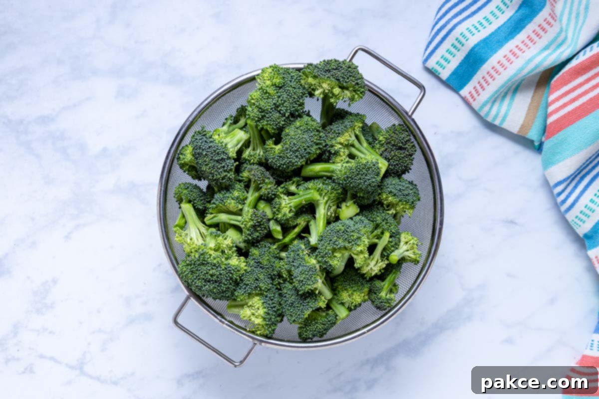 Garlic Roasted Broccoli 4 A strainer full of freshly rinsed and chopped broccoli florets, ready for roasting.