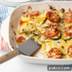 Garden Fresh Tomato and Squash Bake 7 Baked layered casserole of yellow squash, zucchini, and tomatoes with herbs and cheese in a baking dish with a serving removed.
