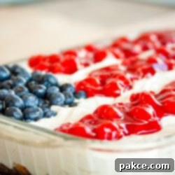 Star-Spangled Fourth of July Cake 3 Fluffy white whipped cream mix over crumbled angel food cake topped with blueberies and cherry pie filling in the design of an American flag in a 9x12 glass pan