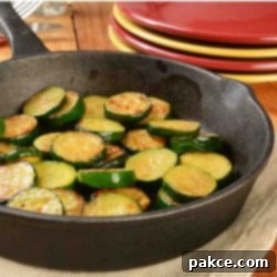 Golden Zucchini Medallions 2 Sautéed zucchini in a cast iron skillet.