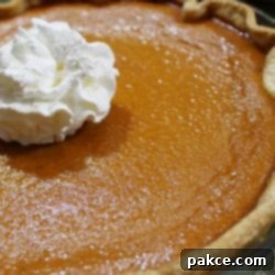 Grandma's Pumpkin Pie 2 Baked pumpkin pie garnished with whipped cream
