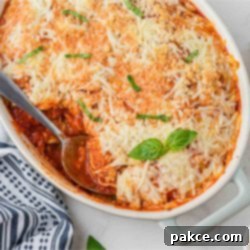 No Boil Baked Frozen Ravioli 6 Casserole dish of baked frozen ravioli with a serving removed.