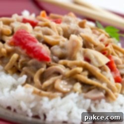 Sandy's Secret Cashew Chicken 2 Chopped chicken with red peppers and mushrooms in a creamy sauce over white rice and garnished with chow mein noodles