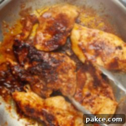 Spicy Chili Lime Chicken with Creamy Coconut Lime Sauce 8 Boneless, skinless chicken breasts in a rich chili sauce being sautéed in a skillet.