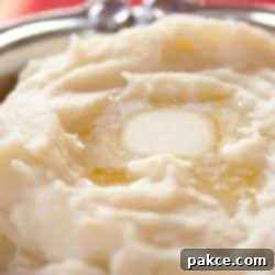Mashed Potatoes with a pat of melting butter.