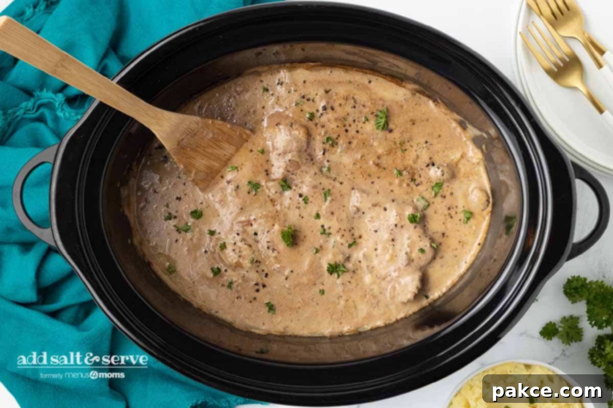 Slow Cooker Creamy Mushroom Cube Steak 6 Cube steak with mushroom soup gravy after cooking in a crock pot.