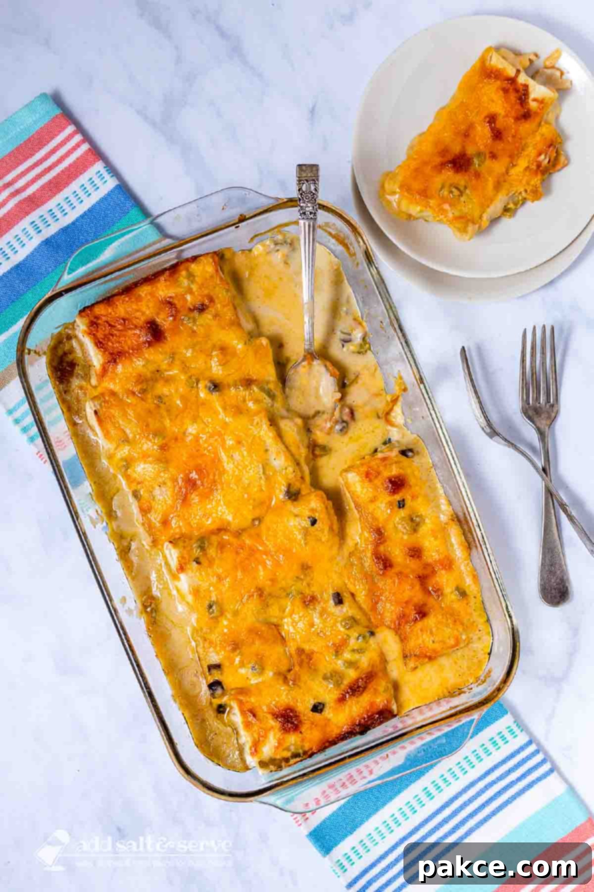 Effortless 5-Ingredient Frozen Burrito Casserole 5 Frozen burrito casserole in a baking dish with a serving on a plate beside it.