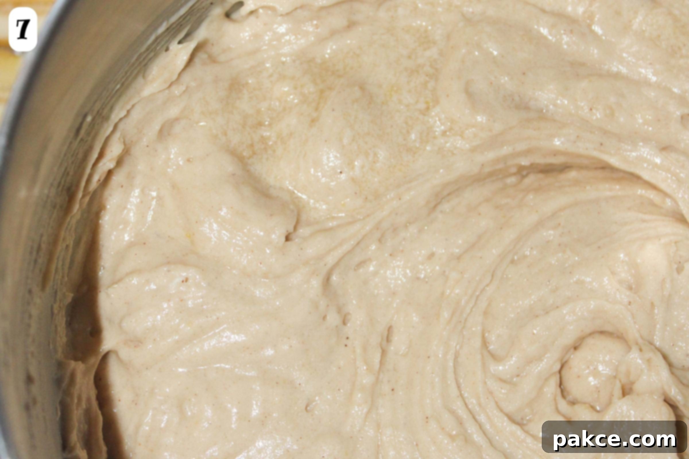 Caramelized Apple Bundt Inversion 6 A close-up view of the completed cake batter in a mixing bowl after all ingredients have been thoroughly combined and mixed to a smooth consistency.