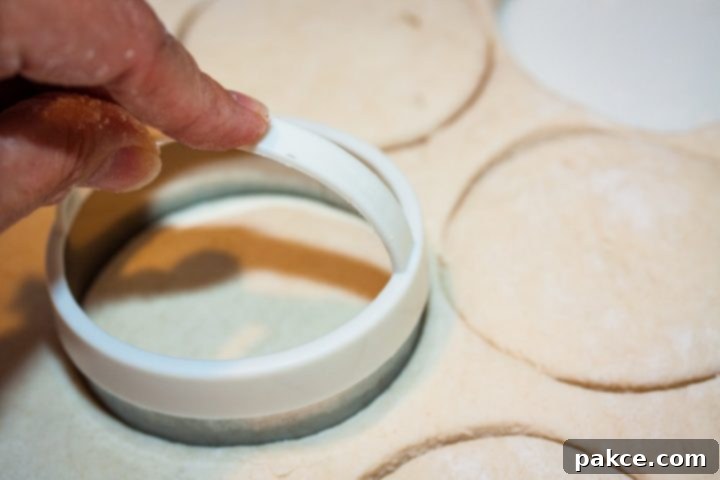 Easy Homemade Buttermilk Biscuits Biscuits being cut out of rolled dough