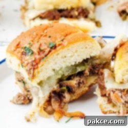 Philly cheesesteak sliders on a plate, ready to be served.