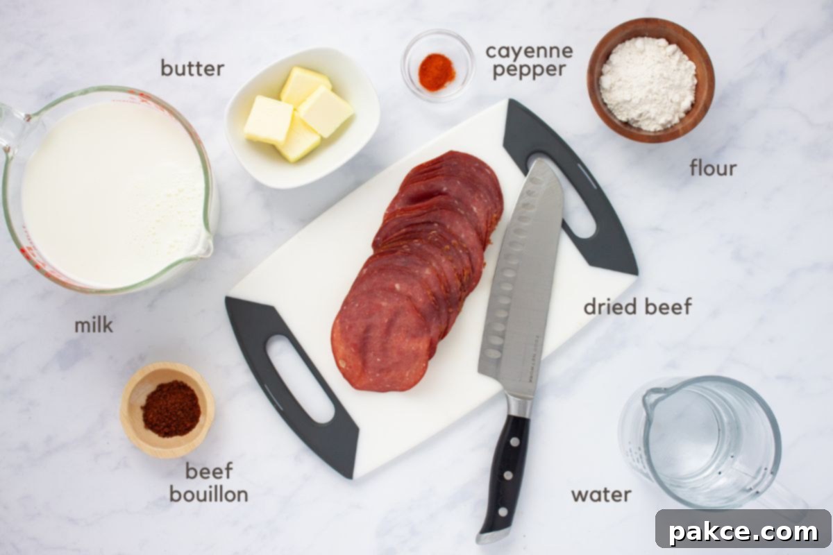 Hearty Chipped Beef Gravy 3 A selection of ingredients for chipped beef gravy laid out on a cutting board: slices of dried beef, a knife, small bowls of flour, beef bouillon, cayenne pepper, butter, and measuring cups with milk and water.