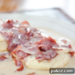 Hearty Chipped Beef Gravy 8 Chipped Beef Gravy and Biscuits on a white plate, ready to be served and enjoyed.