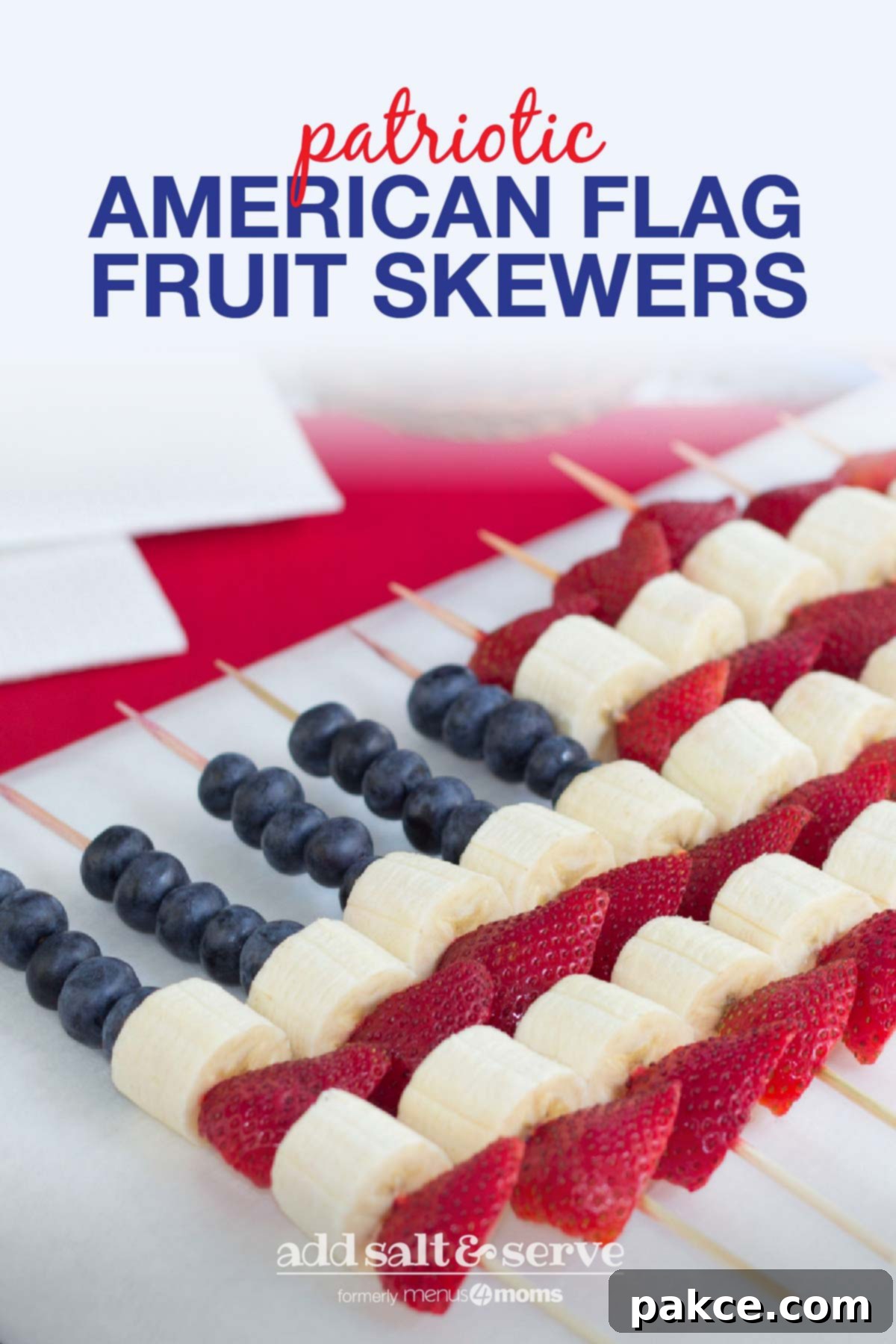 Close-up shot of American Flag Fruit Kabobs on a white serving platter, showing detailed arrangement of blueberries, strawberries, and bananas.
