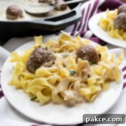 Luscious Creamy Balsamic Meatballs 3 Creamy Balsamic Meatballs in a skillet with egg noodles