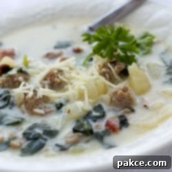 Creamy Tuscan Sausage and Kale Soup 2 Bowl of soup with spinach, potatoes, bacon and cheese