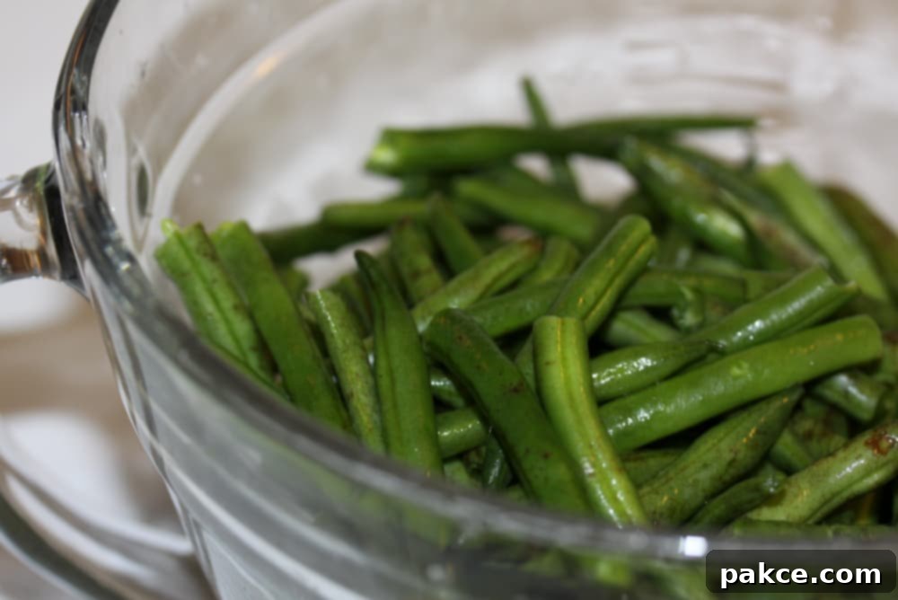 Green Beans Seasoned with Italian Dressing glass bowl of washed and trimmed green beans