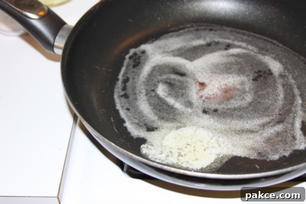 Green Beans Seasoned with Italian Dressing butter melting in a black frypan
