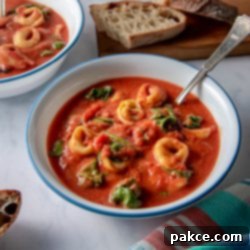 Speedy Tomato Spinach Tortellini Soup 8 Creamy Tomato Spinach Tortellini Soup in a bowl with fresh basil garnish