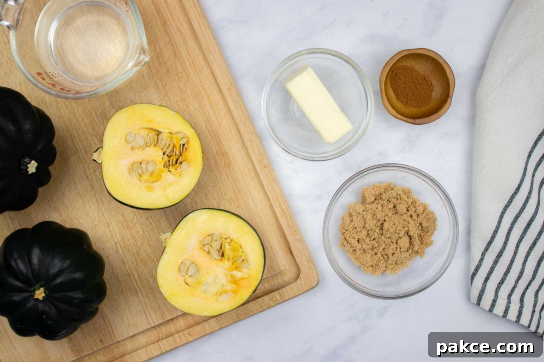 Easy Microwave Acorn Squash 4 Halved acorn squash with butter, brown sugar, and cinnamon on the side.