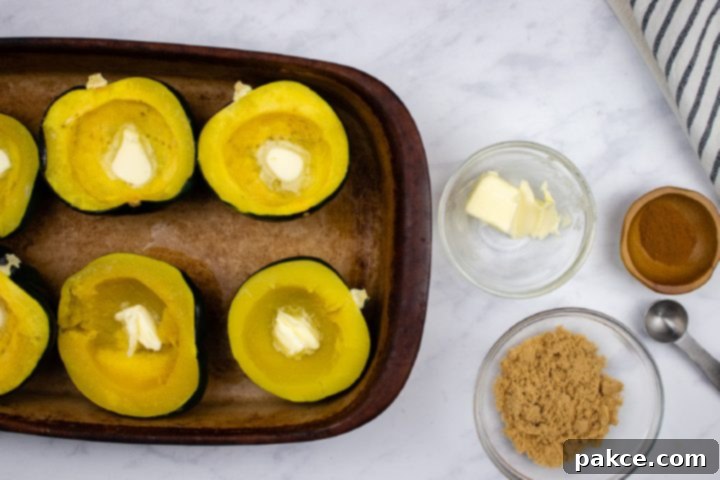 easy-microwave-acorn-squash-ip-3-min Acorn squash halved and steamed in a pan with a pat of butter inside the indentation of each half